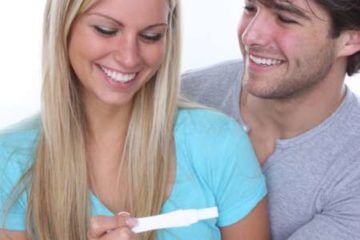 Happy couple viewing positive pregnancy test