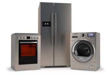 refrigerator flanked by washer and dryer